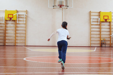 Primary school children a sport lesson indoors