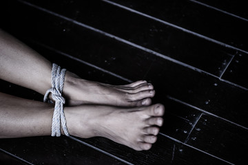 Closeup woman legs were tied with a rope. Violence, Terrified, Human Rights Day concept.