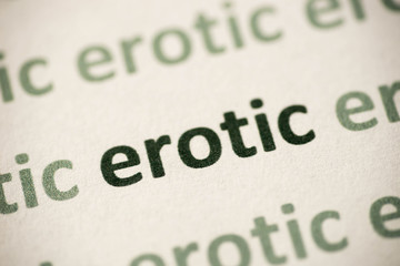 word  erotic  printed on paper macro