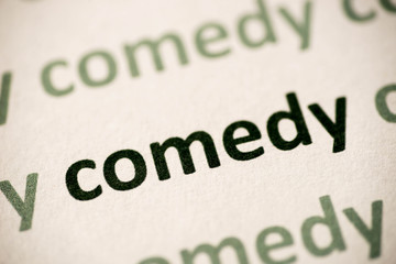 word  comedy  printed on paper macro