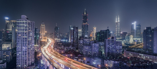 Fototapeta na wymiar aerial view of buildings and traffic multi-level junction at night in Shanghai city
