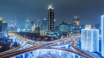 Fototapeta na wymiar aerial view of buildings and highway interchange at night in Shanghai city