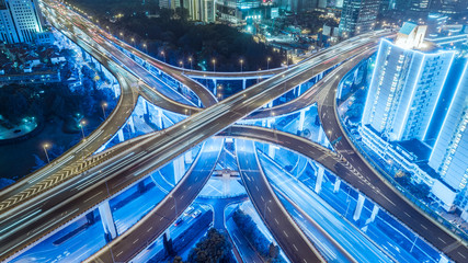 aerial view of buildings and highway interchange at night in Shanghai city