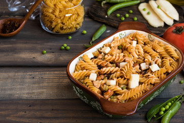 Fusilli pasta with zucchini, goat cheese and green peas