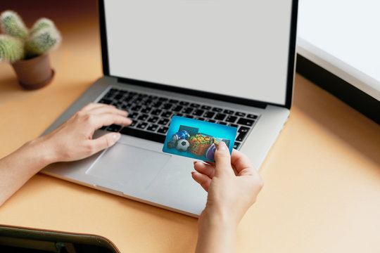 woman holding credit card on laptop for online shopping concept