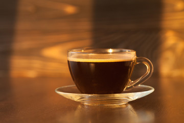 Black roasted arabica coffee beans and cup full of coffee