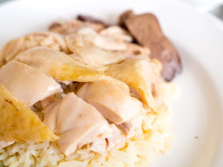 Close up hainanese chicken rice with cucumber on a plate