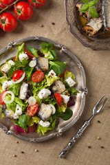 A delicious salad with sardines and feta cheese.