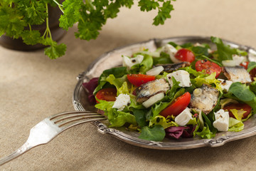 A delicious salad with sardines and feta cheese.