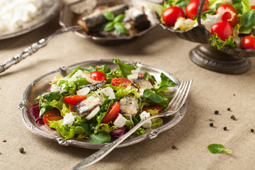 A delicious salad with sardines and feta cheese.
