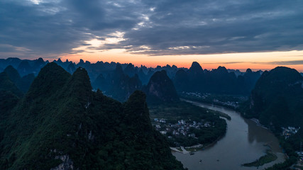 aerial view of farmland, river and mountain in the dawn