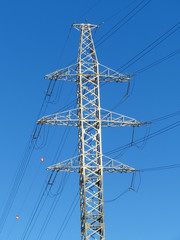 Power poles in the blue sky. Electrical transmission pylon. High voltage.