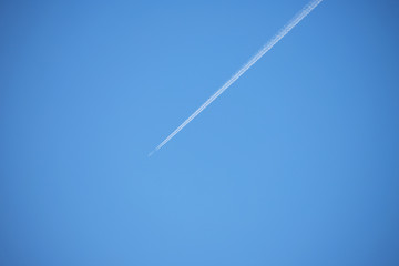 A streak of contrail and blue sky