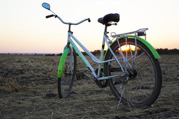 Fototapeta na wymiar Bicycle in the stubble in a wheat field