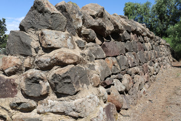 a bluestone and mortar boundary wall fence