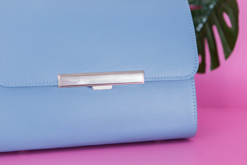 Close-up of a blue fashion bag on the pink background