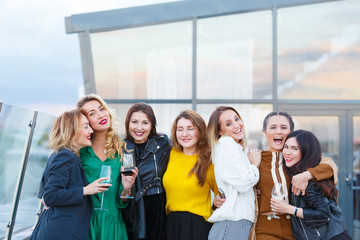 Company of beautiful young stylish women friends met together celebrating birghtday party in an expensive modern restaurant. People, friendship, communion, lifestyle