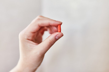 Girl holding a capsule in