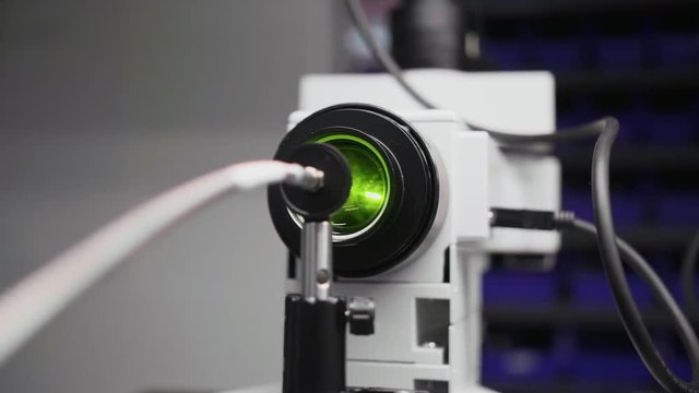 Testing a laser with a microscope in a laboratory.