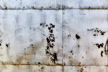 The wall is sheathed by rusty sheets of metal.