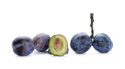 Fresh plums with twigs isolated on white background