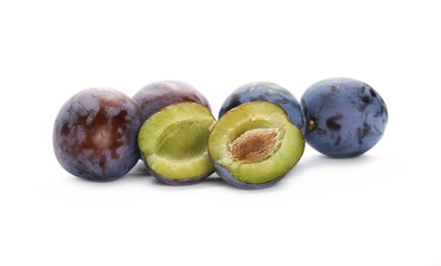 Fresh plums with slices isolated on white background