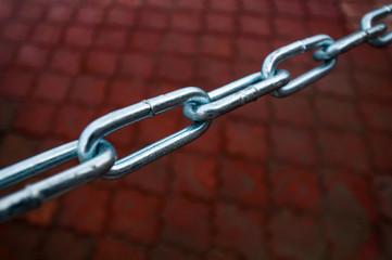 metal chain with large links on red background
