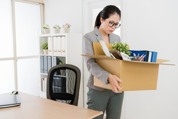 woman packing and leaving her office