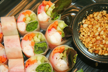 Fresh spring rolls and sweet sauce set on table background