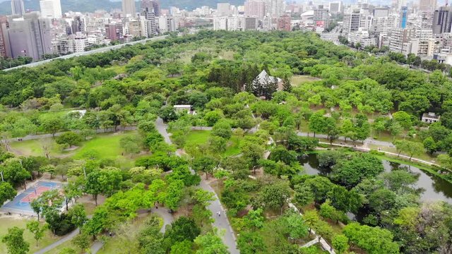 Wide aerial view of lush green Daan Park surrounded by city buildings in Taipei, Taiwan