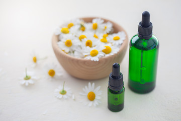 Fototapeta na wymiar aromatherapy essential oil with camomile flowers