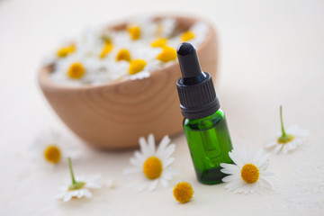aromatherapy essential oil with camomile flowers