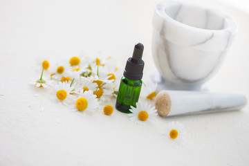 aromatherapy essential oil with camomile flowers