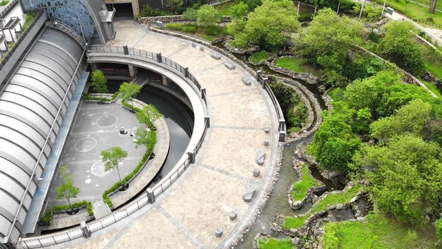Aerial view of curved circular plaza surrounded by green trees in Daan Park, Taipei, Taiwan