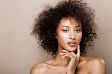Fashion studio portrait of beautiful african american woman with perfect smooth glowing skin, nude make up - Powered by Adobe