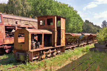Derelict and rusting steam train and coal vagons at the historic Brick factory
