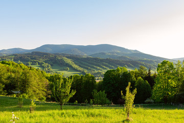 Obraz premium Majestic landscape of mountains and Meadow. Cycling mountain road. Misty mountain road in high mountains.. Cloudy sky with mount