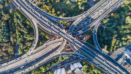 aerial view of highway interchange in sunny day - obrazy, fototapety, plakaty