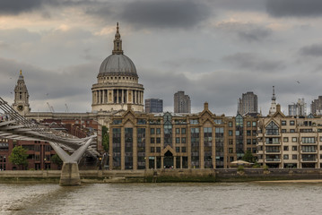 Fototapeta na wymiar St Paul's Cathedral, as seen from the South Bank of the river Thames. The Millennium footbridge can be seen in the left of the picture