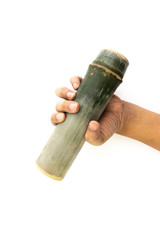 Bamboo tube in the hand of man isolated