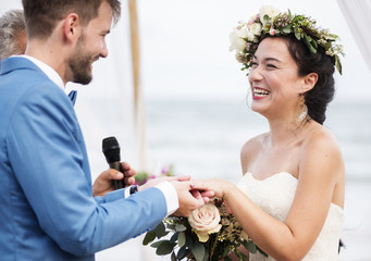 Young couple in a wedding ceremony at the beach