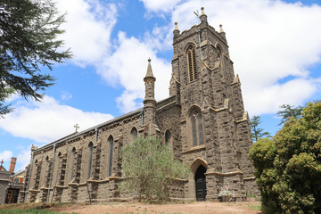 Fototapeta na wymiar KYNETON, AUSTRALIA - February 11, 2018: St Paul’s Church of England (1856) bluestone building has seven bays and a tower which was added in 1928