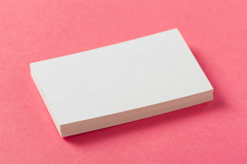 Blank paper pieces  on a colored pink background