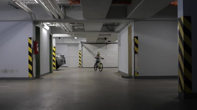 Home Education. Quarantine Viral Infection COVID 19. Self Isolation. Social Distance.  A 4 Year Old Boy Rides A Bicycle In An Underground Parking Lot.