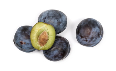 Fresh plums with slice isolated on white background, top view