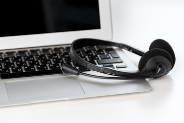 Obraz na płótnie Canvas headset and computer laptop, call center support
