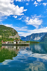 Fototapeta premium Hallstatt, Austria. Touristic pleasure boat arriving to the old