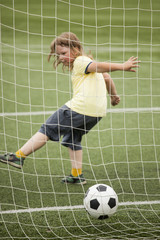child run soccer (football) player. Boy with ball on green grass