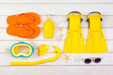 Bright yellow flippers and diving mask on a vibrant backround © fotofabrika