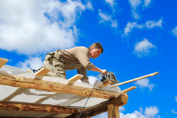 workers make a roof in a country house